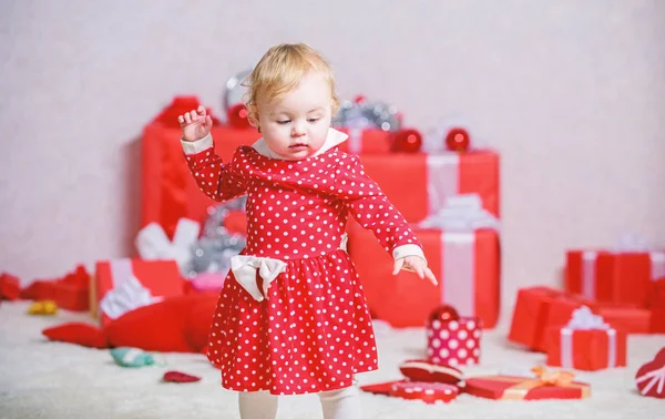 Things to do with toddlers at christmas. Little baby girl play near pile of gift boxes. Family holiday. Christmas activities for toddlers. Christmas miracle concept. Gifts for child first christmas
