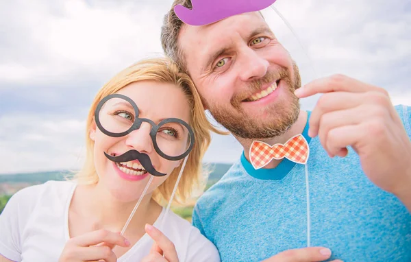 Couple posing with party props sky background. Photo booth props. Man with beard and woman having fun party. Add some fun. Making funny photos birthday party. Just for fun. Humor and laugh concept