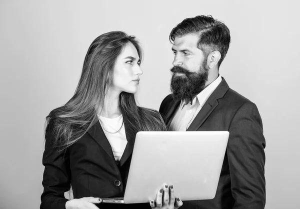 Business meeting. Man bearded manager show financial report laptop. Discussing progress. Woman and guy colleague working together. Business plan. Business lady and director or boss surfing internet