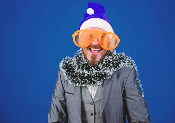 Man bearded hipster wear santa hat and funny sunglasses. Manager tinsel ready celebrate new year. Christmas party office. Corporate holiday party ideas employees will love. Corporate christmas party