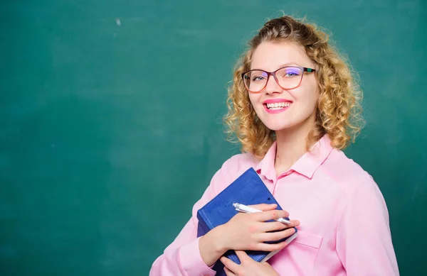 Teacher best friend of learners. Passionate about knowledge. Pedagogue hold book and explaining information. Education concept. Teacher explain hard topic. Woman school teacher in front of chalkboard