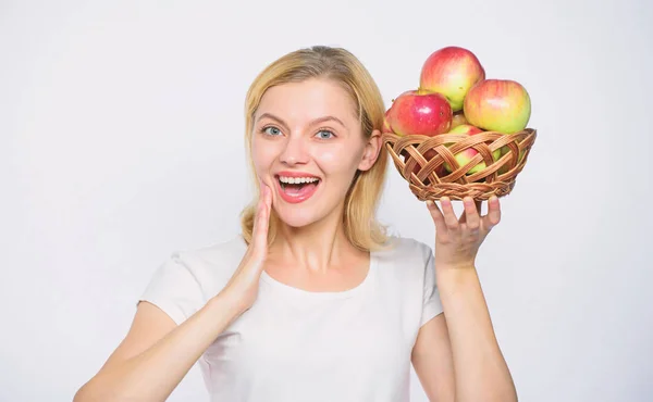 Rich harvest. vitamin diet and food shooping. farming concept. healthy teeth. orchard, gardener girl with apple basket. Happy woman eating apple. autumn harvest. Spring seasonal fruit