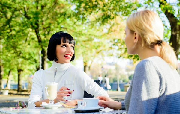 Girls friends drink coffee and enjoy talk. True friendship friendly close relations. Conversation of two women cafe terrace. Friendship meeting. Togetherness female friendship. Trustful communication