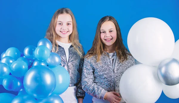 Having fun concept. Balloon theme party. Girls little siblings near air balloons. Birthday party. Happiness and cheerful moments. Carefree childhood. Start this party. Sisters organize home party