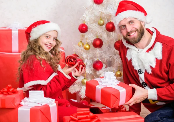 Father christmas concept. Dad in santa costume give gift to daughter cute kid. Happy childhood. Christmas family holiday. Christmas gift for child. Make your childs holiday extra special this year