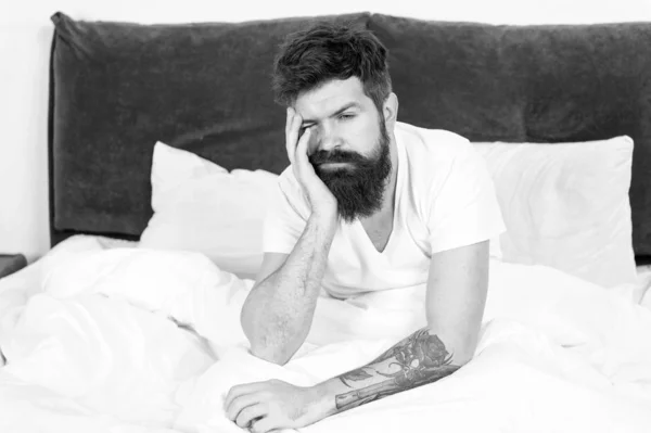 energy and tiredness. Sleepy and handsome. asleep and awake. Too early to wake up. bearded man hipster sleep in morning. Tired and overworked. sleepy man in bedroom. male with beard in pajama on bed