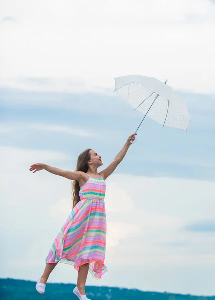 Girl with light umbrella. Fairy tale character. Happy childhood. Feeling light. Anti gravitation. Fly drop parachute. Dreaming about first flight. Kid pretending fly. I believe i can fly. Touch sky