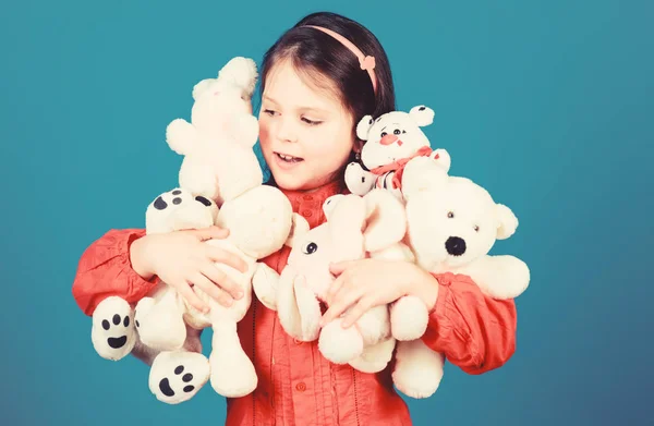 Small girl smiling face with toys. Happy childhood. Little girl play with soft toy teddy bear. Lot of toys in her hands. Childhood concept. Collecting toys hobby. Cherishing memories of childhood — Stock Photo, Image