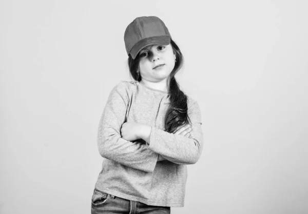 Cutie in cap. Modern fashion. Stylish accessory. Kids fashion. Feeling confident with this cap. Girl cute child wear cap or snapback hat beige background. Little girl wearing bright baseball cap — Stock Photo, Image