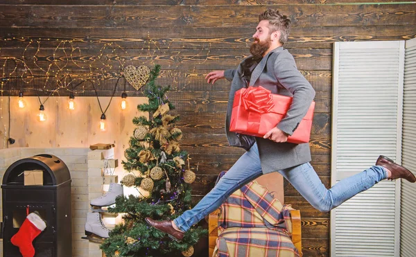 Man hold box hurry to deliver gift on time. Spread happiness and joy. Bearded guy in motion jump. Delivery christmas present. Gifts delivery. Still have time. Delivery service. Christmas is coming