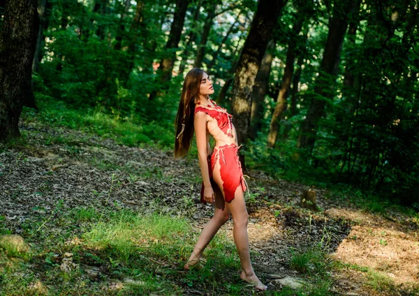 Forest fairy. Living wild life untouched nature. Wild woman in forest. Sexy girl early stage in the evolutionary development. Culture of wild human. Female spirit mythology. Fashion primitive design