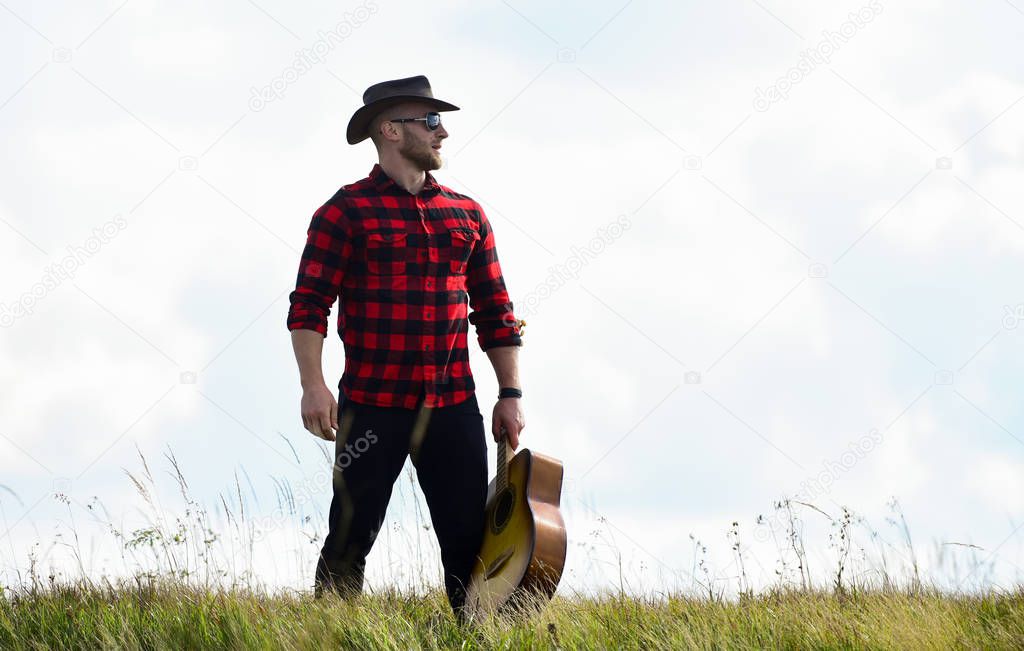 Solely Graceful. hipster fashion. happy and free. western camping and hiking. cowboy man with acoustic guitar player. sexy man with guitar in checkered shirt. country music song