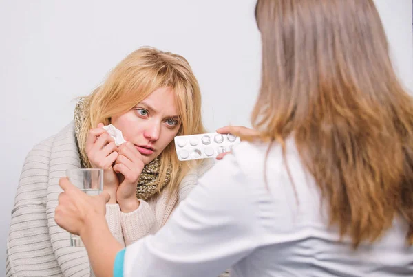 Giving respiratory drug. Primary care doctor making diagnosis to sick woman. Doctor visiting unhealthy woman at home. Medical doctor examining patient. Patient care and healthcare