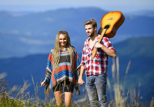 Deep in love. couple in love spend free time together. western camping. hiking. happy friends with guitar. friendship. campfire songs. country music. romantic date. men play guitar for girl