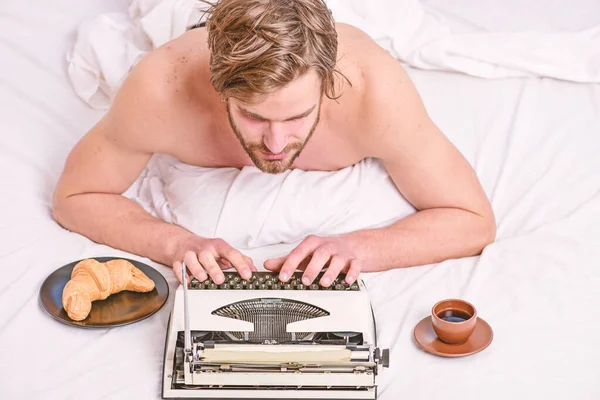 Man writer lay bed with breakfast working. Morning bring fresh idea. Morning inspiration. Erotic literature. Daily routine of writer. Writer handsome author used old fashioned manual typewriter