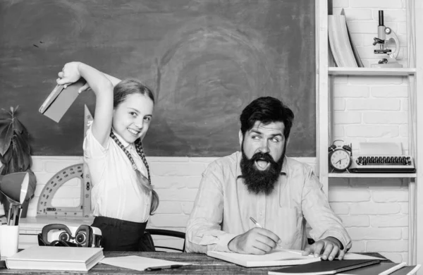 literature lesson. private lesson. small girl child with bearded teacher man in classroom. knowledge day. Home schooling. back to school. Private teaching. daughter study with father. Teachers day