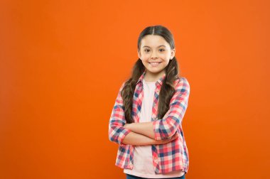 confident girl. kid long hair. small girl checkered shirt. happy child. happy childrens day. childhood memory. little girl orange background. kid fashion. smiling school girl. copy spac