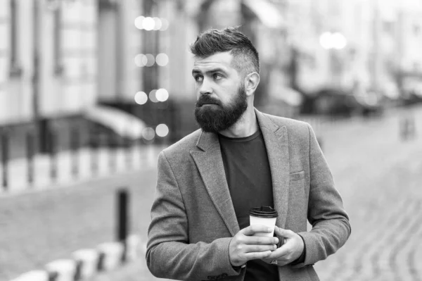 Get some rest after hard day. Man bearded hipster drink coffee paper cup. Businessman well groomed enjoy coffee break outdoor urban background. Thoughtful but relaxed. Walk and enjoy fresh hot coffee — Stock Photo, Image