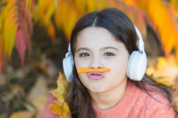 Listening song. Autumn playlist concept. Enjoy music outdoors fall warm day. Audio file. Educational podcast. Feel joy. Kid girl relaxing near autumn tree with headphones. Music for autumn cozy mood