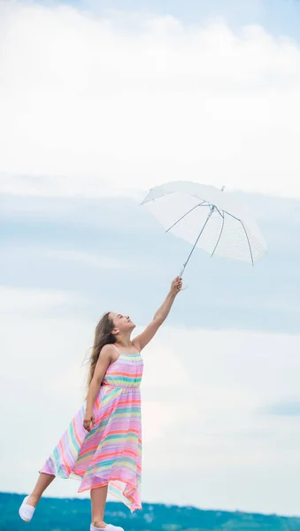 Girl with light umbrella. Anti gravitation. Fly drop parachute. Dreaming about first flight. Kid pretending fly. I believe i can fly. Touch sky. Fairy tale character. Happy childhood. Feeling light