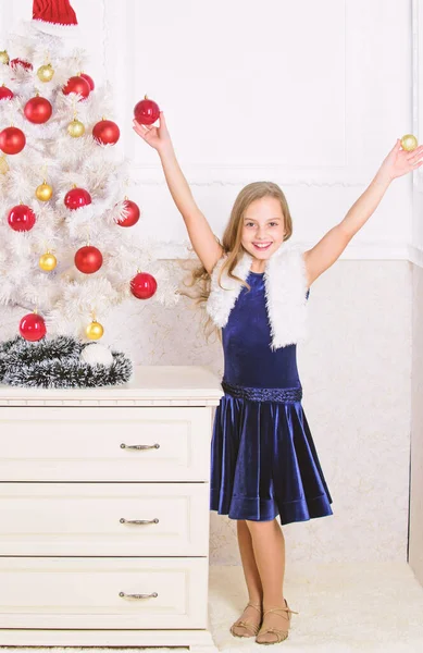 Very special time of year. Spread christmas cheer. Kid happy because holiday season arrives. Winter holiday concept. Family holiday concept. Girl velvet dress feel festive near christmas tree