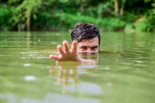 scary man comes from deep water. bearded man swimming in lake. summer vacation. mature swimmer. brutal hipster with wet beard. refreshing in river water. water beast. furry wild man. time to relax