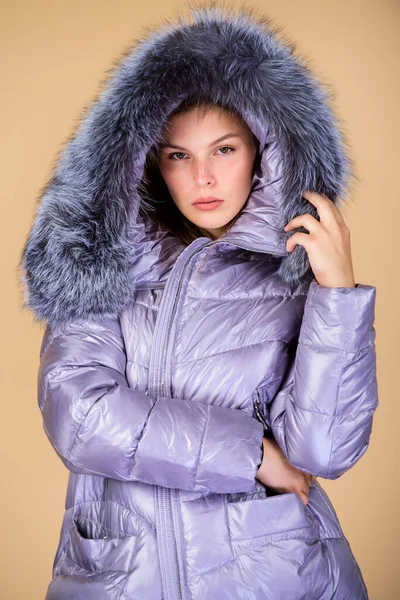 Fashion friends. Winter season. Soft fur. For those wishing stay modern.  Winter clothes. Women wear down jacket with furry hood. Girls smiling  makeup faces wear winter jackets blue background Stock Photo by ©