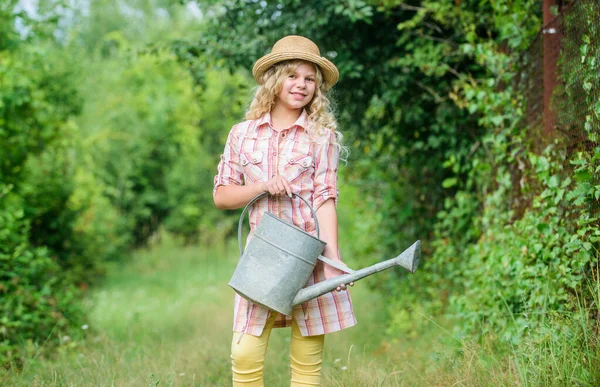Improve irrigation timing. Optimize water use. Watering plants in garden. Girl child hold watering can. Spring gardening checklist. Watering tools. Measure soil water content temperature and salinity — Stock Photo, Image