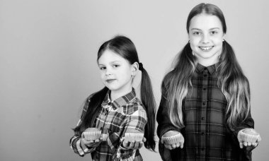 Kız kardeşler pişmiş Muffins tutar. Ev yapımı yemek. Diyet sağlıklı beslenme ve kalori. Nefis Muffins. Kızlar Sevimli çocuklar kekler veya Cupcake yiyor. Tatlı tatlısı. Mutfak tarifi. Lezzetli atıştırmalık. Pişirme becerisi