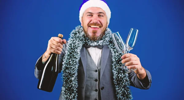 Corporate christmas party. Man bearded cheerful hipster santa hold champagne and glasses. Christmas party organisers. Boss tinsel ready celebrate new year. Corporate party ideas employees will love