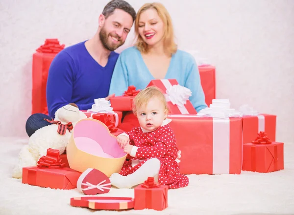 Love is in the air. Happy family with present box. Love and trust in family. Bearded man and woman with little girl. father, mother and doughter child. Shopping. Boxing day. Valentines day. Red boxes