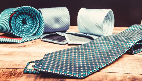 Perfect necktie close up. Shopping concept. Personal stylist service. Stylist advice. Matching necktie with outfit. Pick necktie. Different blue color necktie. Menswear clothes and accessories