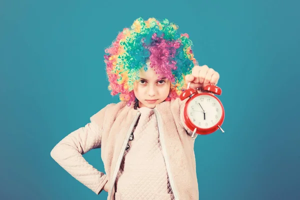 False alarm. Girl worry about time. Time to have fun. Discipline and time concept. Circus performance timing. Kid colorful curly wig clown style hold alarm clock. I am not joking about discipline — Stock Photo, Image