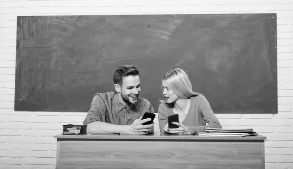 Look at this. Back to school. Couple of man and woman in classroom. Home schooling. Modern school. Knowledge day. Student life. Lesson and blackboard. Teachers day. Happy couple — Stock Photo, Image