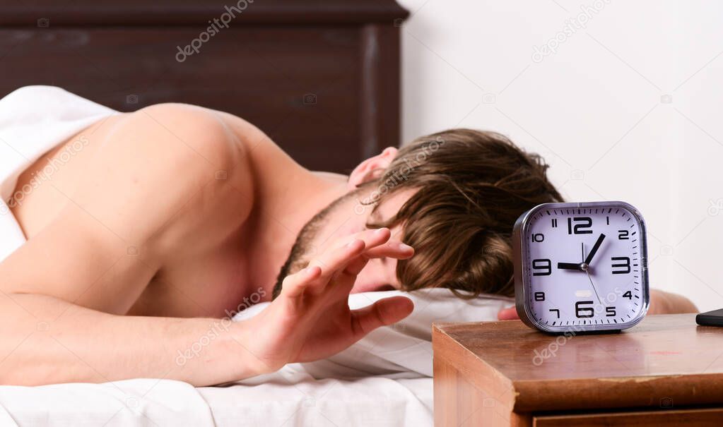 Man stretching in bed. Stretch after wake up in the morning. Man waking up happy.