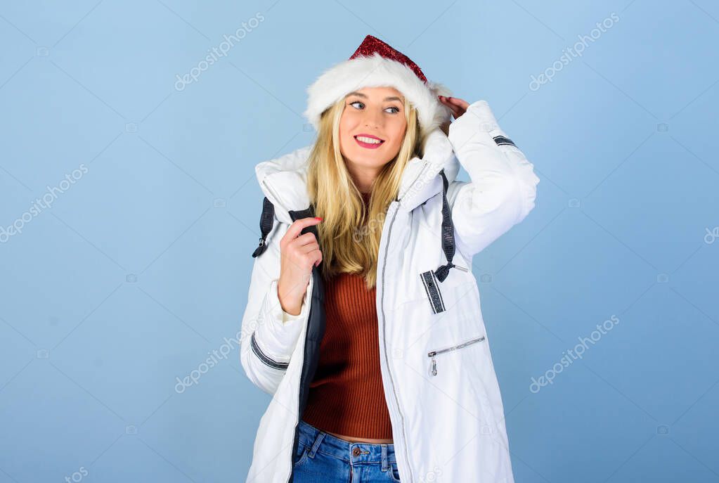 Are you ready. morning before xmas. winter holidays and vacation. woman in down jacket. girl santa claus hat. padded coat fashion. warm clothing. fun and gifts. happy new year. merry christmas