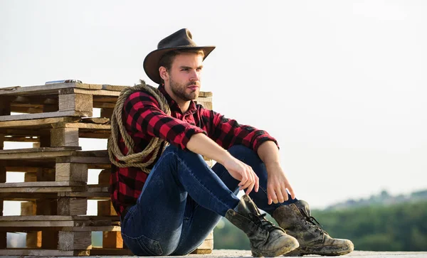 Being a Texan. Vintage style man. Wild West retro cowboy. cowboy with lasso rope. Western. wild west rodeo. Thoughtful man in hat relax. western cowboy portrait. man checkered shirt on ranch — Stock Photo, Image