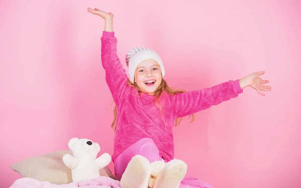 Kid cute girl play with soft toy teddy bear pink background. Unique attachments to stuffed animals. Teddy bears improve psychological wellbeing. Child small girl playful hold teddy bear plush toy