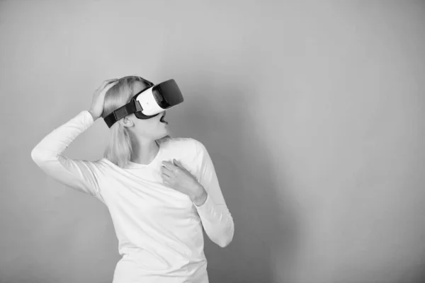 Woman using virtual reality headset. Young woman using a virtual reality headset with conceptual network lines. Young woman using a virtual reality headset. Future data.