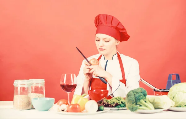 restaurant menu. Dieting. happy woman cooking healthy food by recipe. professional chef on red background. organic eating and vegetarian. Housewife. woman in cook hat. Chef cooking vegetarian recipe