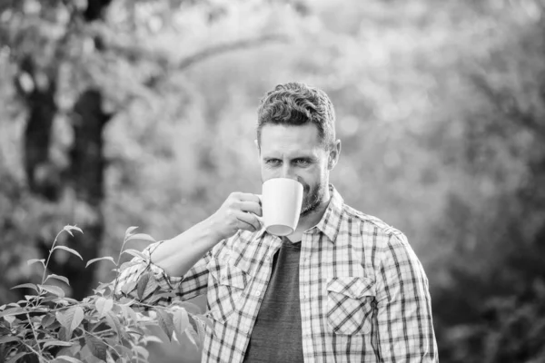 drink tea outdoor. morning coffee. healthy lifestyle. nature and health. breakfast refreshment time. ecological life for man. man in green forest. happy man with cup of tea. Enjoying morning coffee