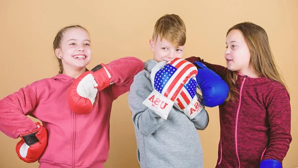 punching knockout. Childhood activity. Sport success. Team fight. workout of small girls and boy boxer in sportswear. Happy children in boxing gloves. Fitness diet. energy health. Resting time