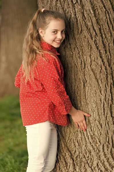 Good vibes only. Girl little cute child enjoy peace and tranquility at tree trunk. Place of power. Peaceful place. Find peace and relax in nature. Calm and peaceful. Life balance. Peaceful mood
