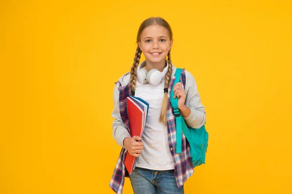 Motivated and diligent. Stylish schoolgirl. Girl little fashionable schoolgirl carry backpack. Schoolgirl daily life. School club. Modern education. Private schooling. Teen with backpack and books