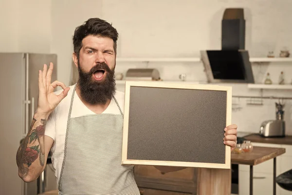 Providing training course. Bearded cook with ok sign holding blackboard in training school. Hipster man giving training course in cooking. Culinary school and training, copy space
