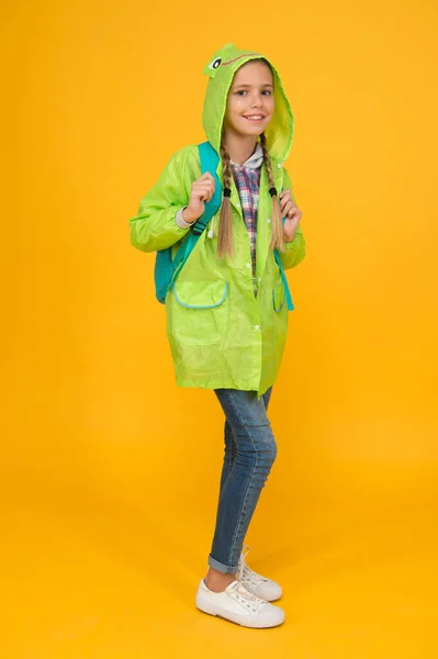 Waterproof cloak. Waterproof fabric for your comfort. Rainproof accessory. Schoolgirl hooded raincoat enjoy rainy weather. Waterproof clothes every kid should try. Kid girl happy wear raincoat