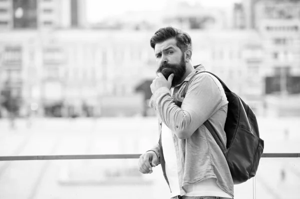 Tourist handsome hipster with backpack stand street. Man with beard and rucksack explore city. Travelling and adventures concept. Tourist on vacation. Hipster modern tourist urban background — Stock Photo, Image