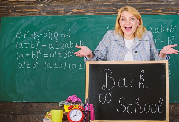 Back to school. Teachers day. Study and education. Modern school. Knowledge day. woman in classroom. School. Home schooling. happy woman. teacher with alarm clock at blackboard. Time. Amazing story