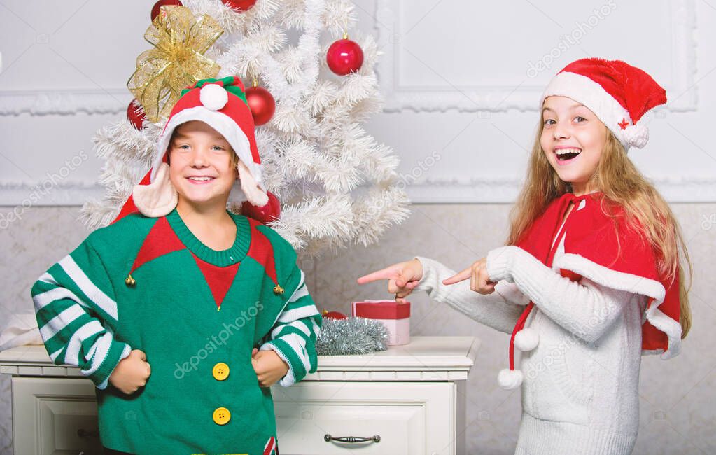 Kids christmas costumes santa and elf. Winter masquerade concept. Siblings ready celebrate christmas or meet new year. Merry christmas. Family holiday tradition. Children cheerful celebrate christmas