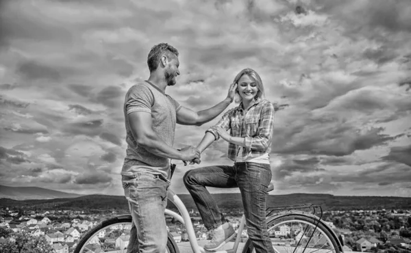 How to meet girls while riding bike. Man with beard and shy blonde lady on first date. Picking up girl. Couple just meet to become acquainted. Woman feels shy in company with attractive macho